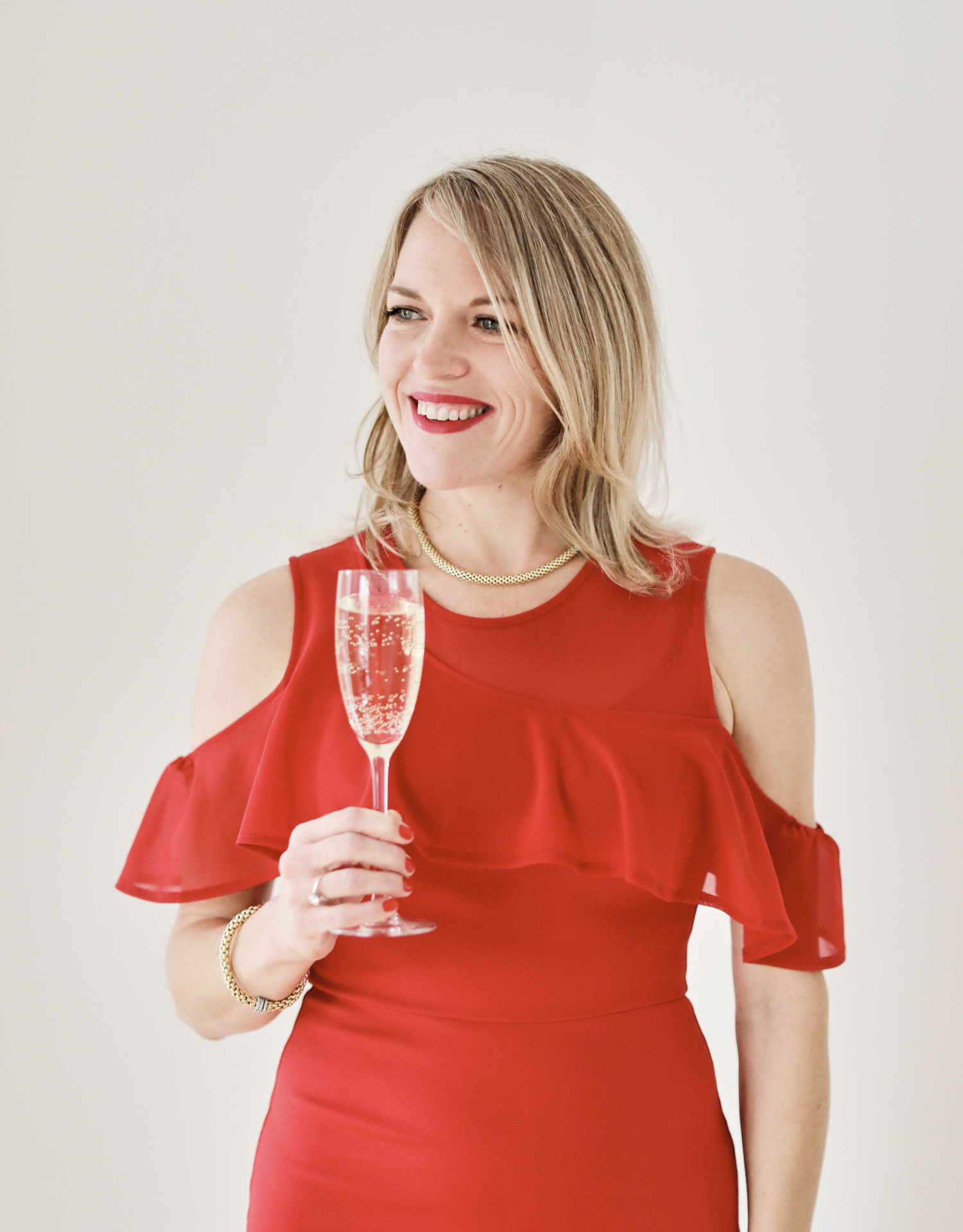 Kristin Perrin Sommelier and storyteller photo in red dress with wine